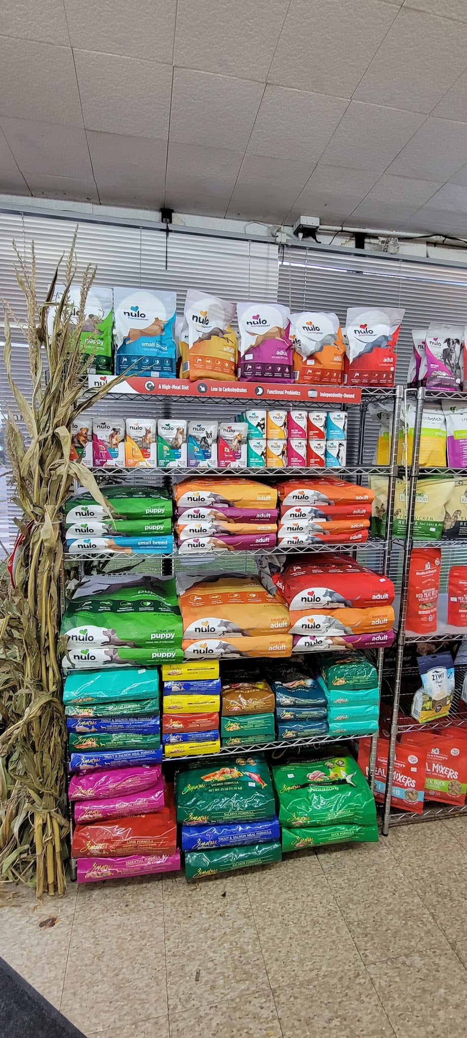 Store shelves stocked with Nulo and Zignature dry pet food bags
