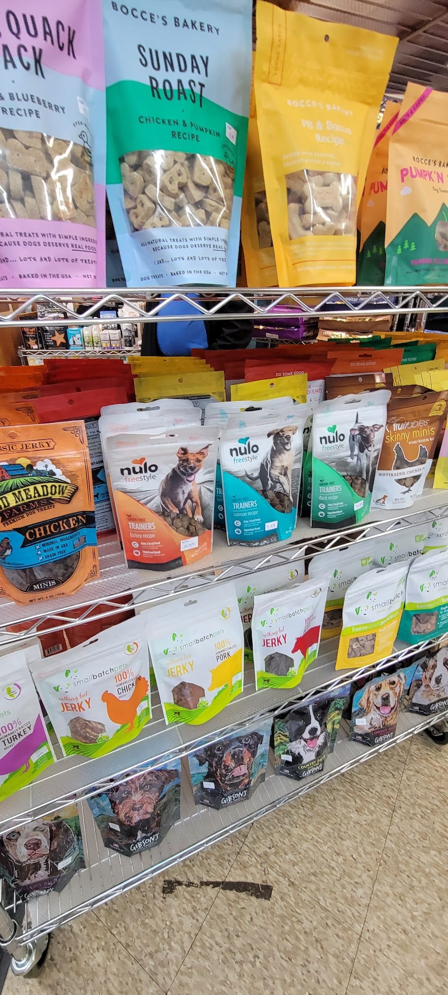 Pet store shelf stocked with dog treat brands including Nulo, Bocce's Bakery, and Small Batch Jerky