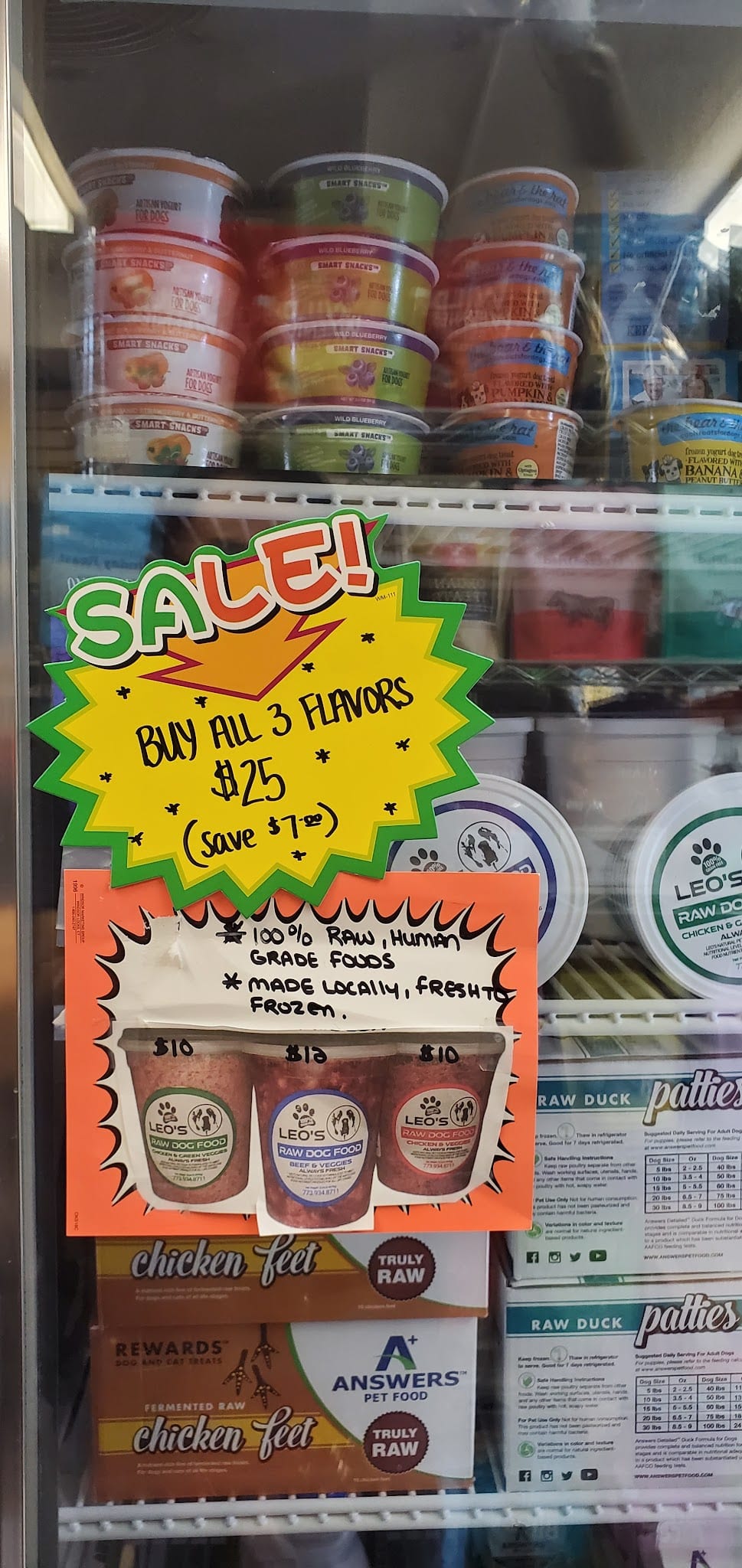 Freezer display showing Leo's Raw Dog Food sale sign, buy all 3 flavors for $25